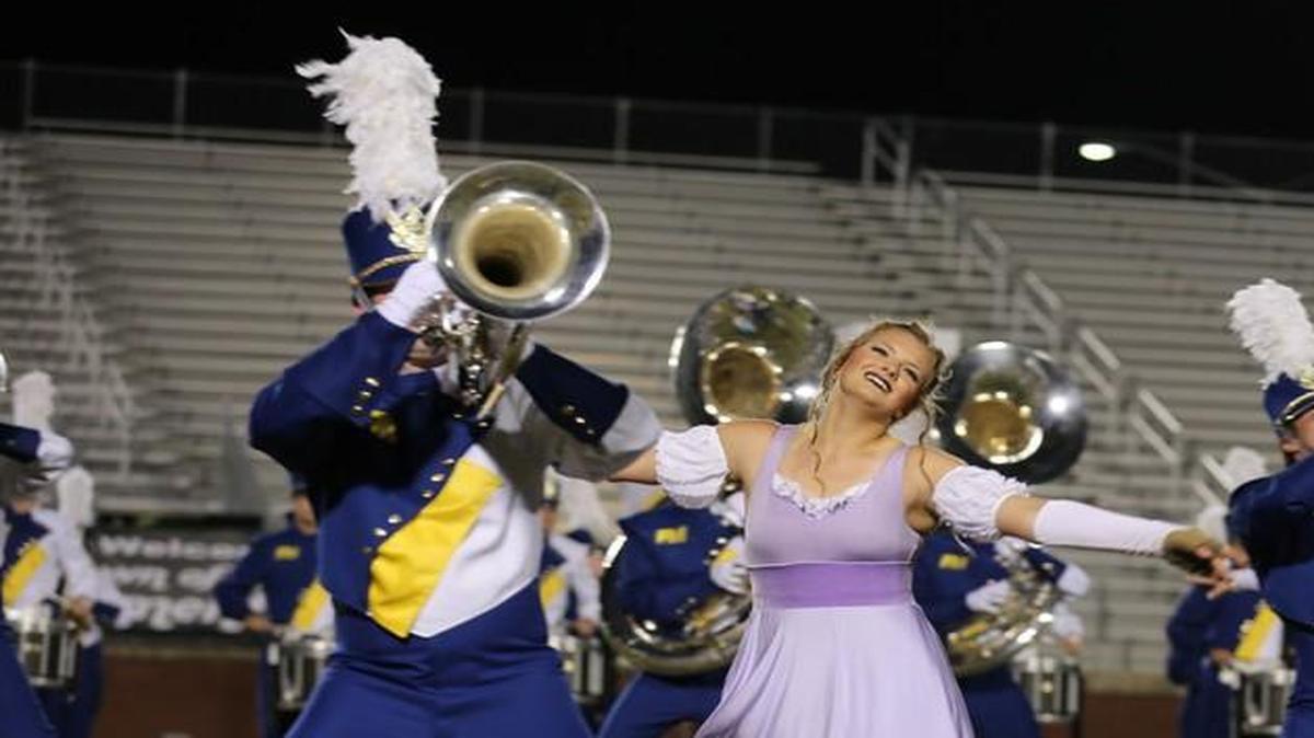 
Fort Mill High’s brass players and color guard interact during the waltz scene of the band’s performance.
