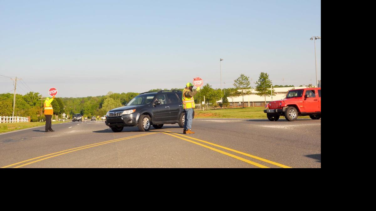 
Crossing guards direct traffic at Friday morning at the intersection of Highway 557 and Oakridge Road in Lake Wylie. The intersection will have a new traffic signal by the end of summer.
