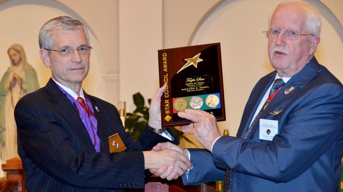 Rick Engel, left, grand knight of All Saints Council No. 14475, is presented the prestigious Triple Star Award by Knights of Columbus State Deputy Frank Davis on Nov. 10 at the Lake Wylie church.