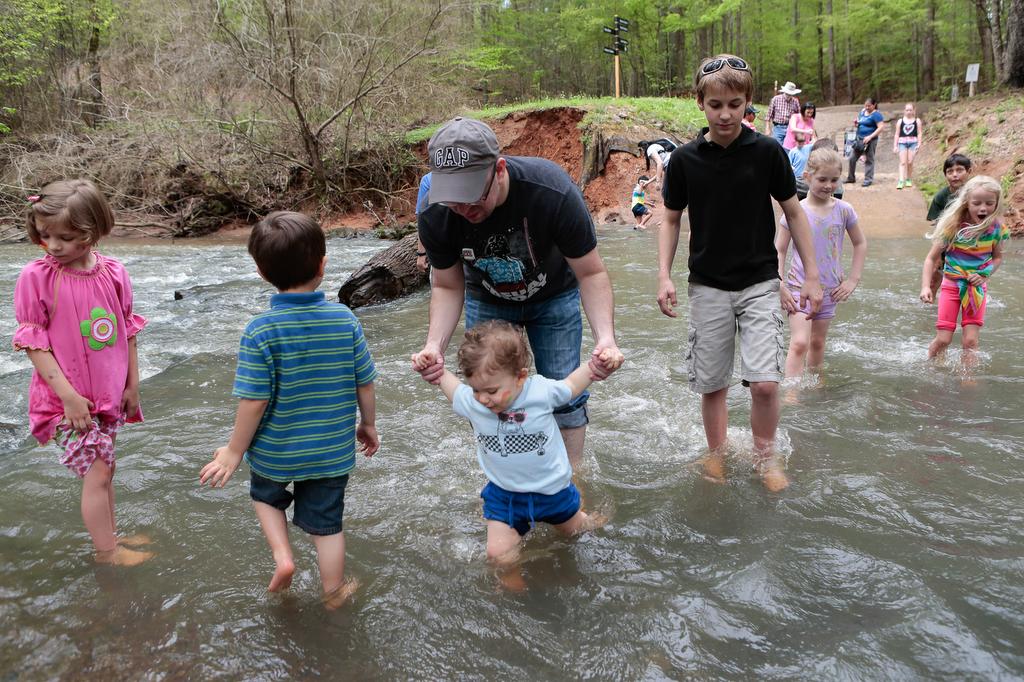 
At Saturday’s 20th anniversary Earth Day celebration at the Anne Springs Close Greenway, visitors splash around in the creek on what turned out to be a nice day.
