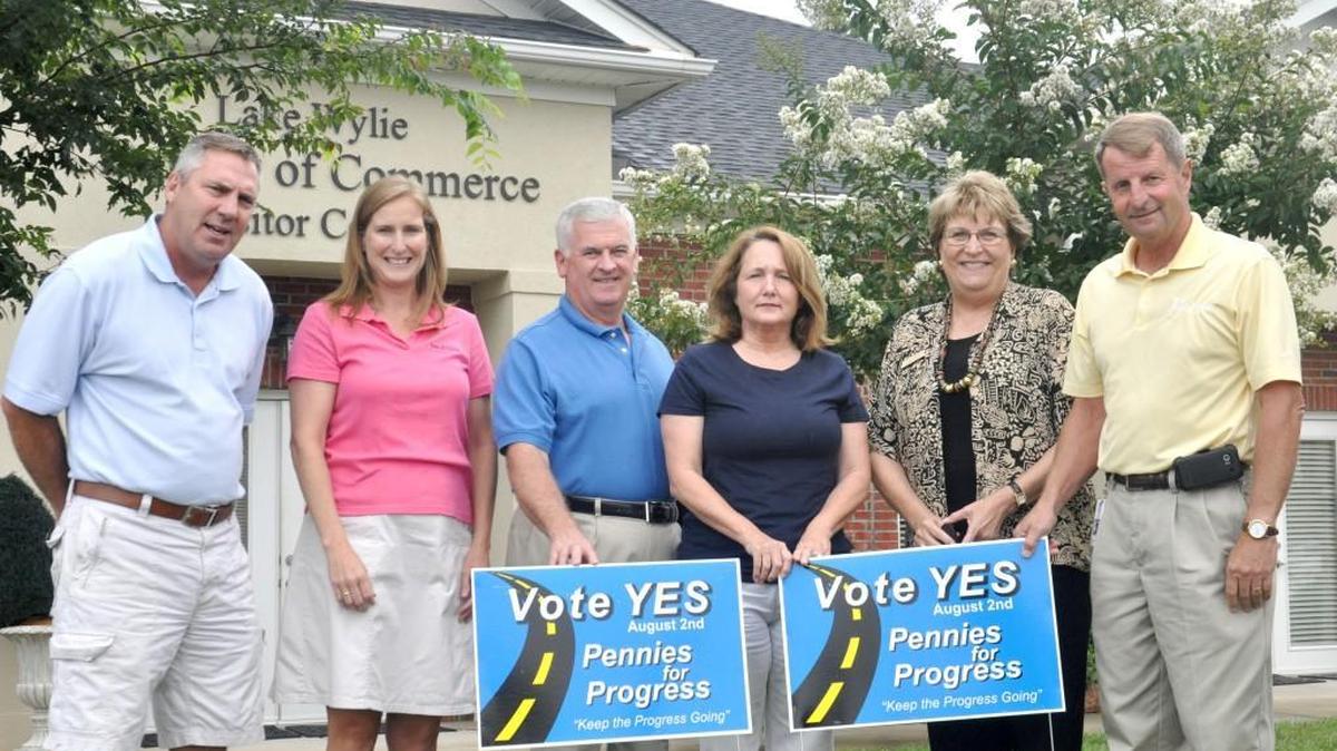 Local leaders stand in front of the signs for the Pennies for Progress vote outside the Lake Wylie Chamber of Commerce and Visitor Center office on Latitude Lane in Lake Wylie.York County Council voted Aug. 21 not to fund the Lake Wylie Visitor Center through hospitality tax money.