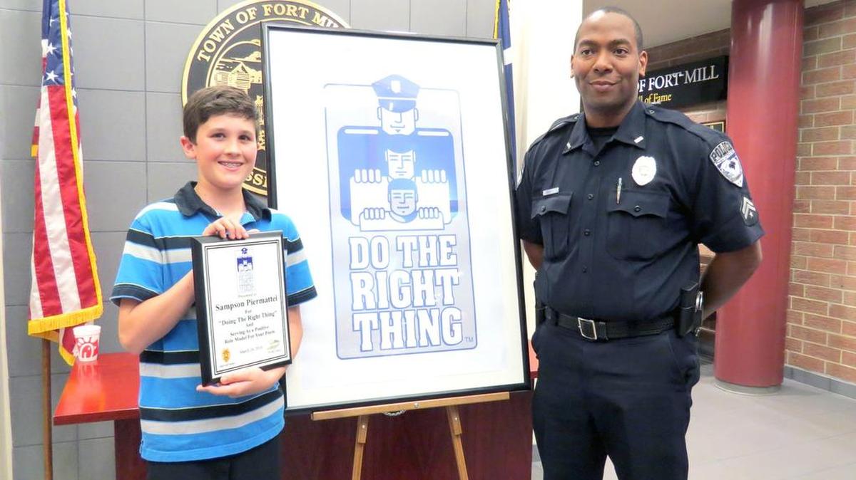 Do The Right Thing grand prize winner Sampson Piermattei shows off his award with Fort Mill Police Officer Johnathan Gilbert, who runs the program.