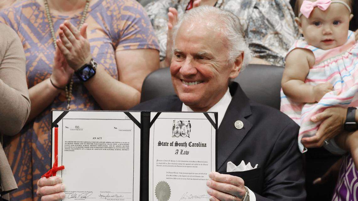 S.C. Governor Henry McMaster shows off a bill he signed at South Pointe High School on Wednesday that gives parental leave to new parents in South Carolina school districts.