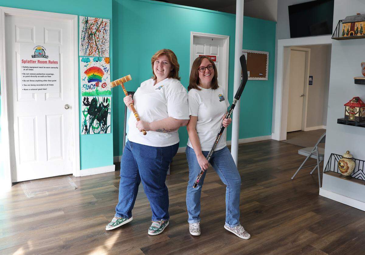 Heidi Inman, left, and Cheryl Yeager, co-owners of T-Wrecks Smash and Paint Splatter Rooms stand in their store on East Main Street in Rock Hill.