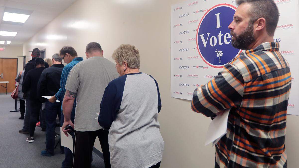 Voters wait in line at the York County Registration and Elections office in York for early voting Monday.