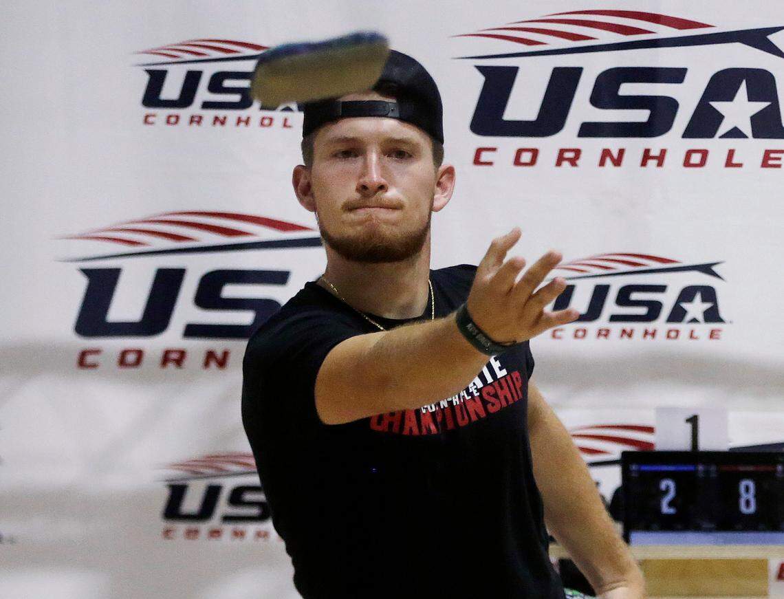 Gabe Dolen, left, of Zanesville, Ohio competes Friday in the USA Cornhole Championships at the Rock Hill Sports and Event Center.