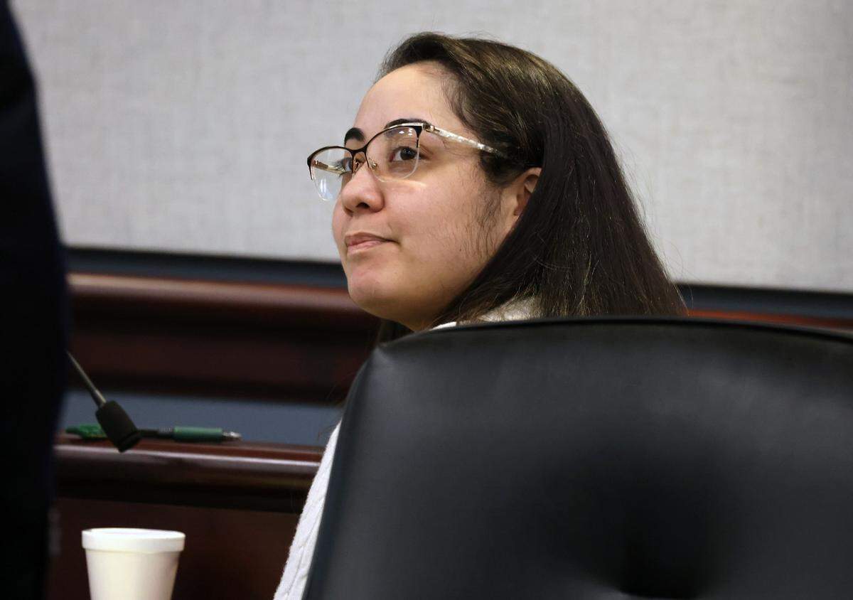 Jackleen Elizabeth Mullen listens to her lawyer Tuesday in court at the Moss Justice Center. Mullen is on trial for murder, homicide by child abuse and aiding and abetting homicide by child abuse in the death of her daughter.