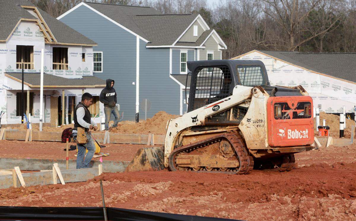 A construction crew works on a site at the new Lennar Elizabeth subdivision off the Fort Mill Parkway on Saturday, Jan. 21, 2023.