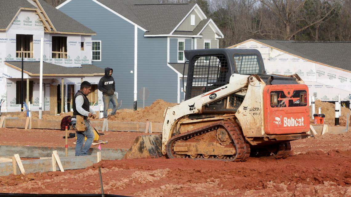 A construction crew works on a site at the new Lennar Elizabeth subdivision off the Fort Mill Parkway on Saturday, Jan. 21, 2023.