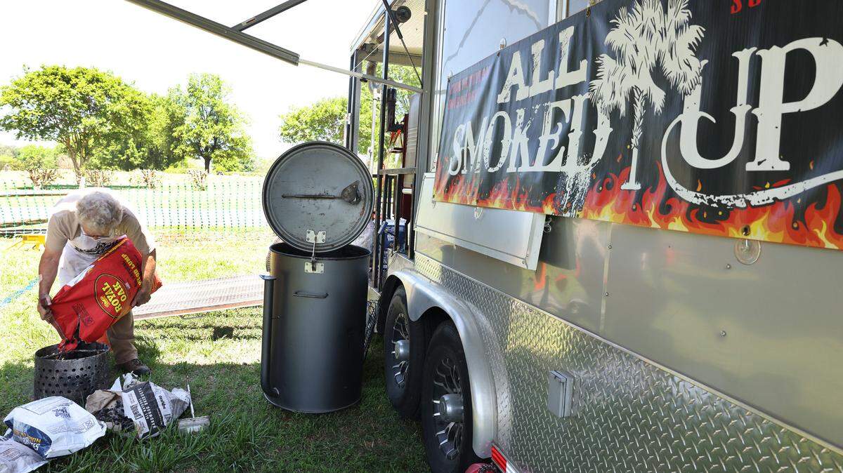 Gary Taylor of “All Smoked Up” of Lexington, S.C., prepares to cook for the Barbecue Cook-Off and Anything But Butts competitions Friday at the Come-See-Me Festival in Rock Hill.