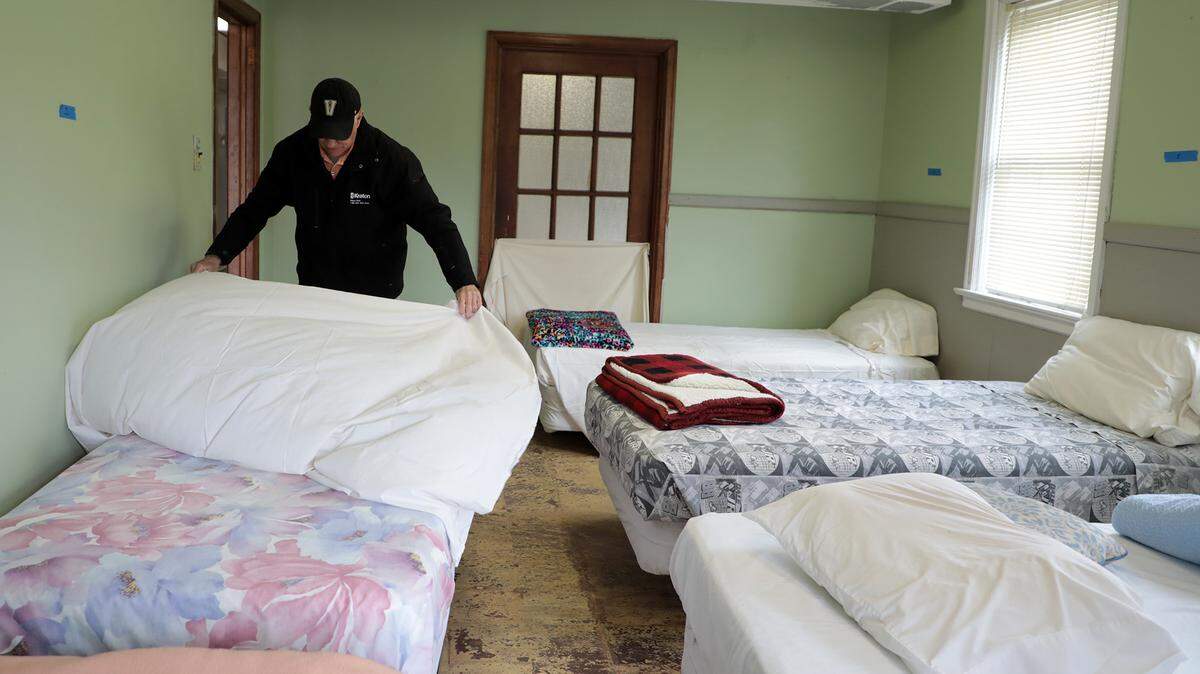 In this Herald file photo, Pete Richardson makes a bed at the Bethel Men’s Shelter. Bethel and other area homeless shelters are preparing to help people in need as extreme cold temperatures are forecast over the holidays.