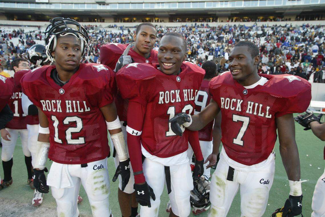 Phillip Adams, center, is surrounded by teammates Devin Ware, left, Ladarious Moore, right, and Tori Gurley, behind, as they celebrate winning the Big 16 state championship against Stratford in 2004.