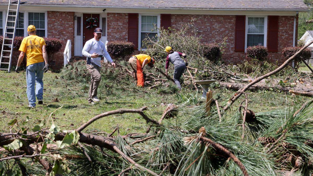 Volunteers with the South Carolina Baptist Convention Disaster Relief group help clean up a yard Wednesday on Post Lane in Rock Hill.