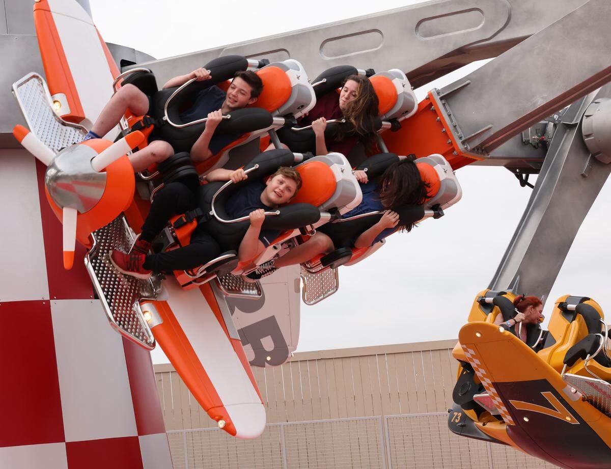 Riders scream Thursday on the Air Racers attraction at Carowinds’ new Aeronautica Landing.