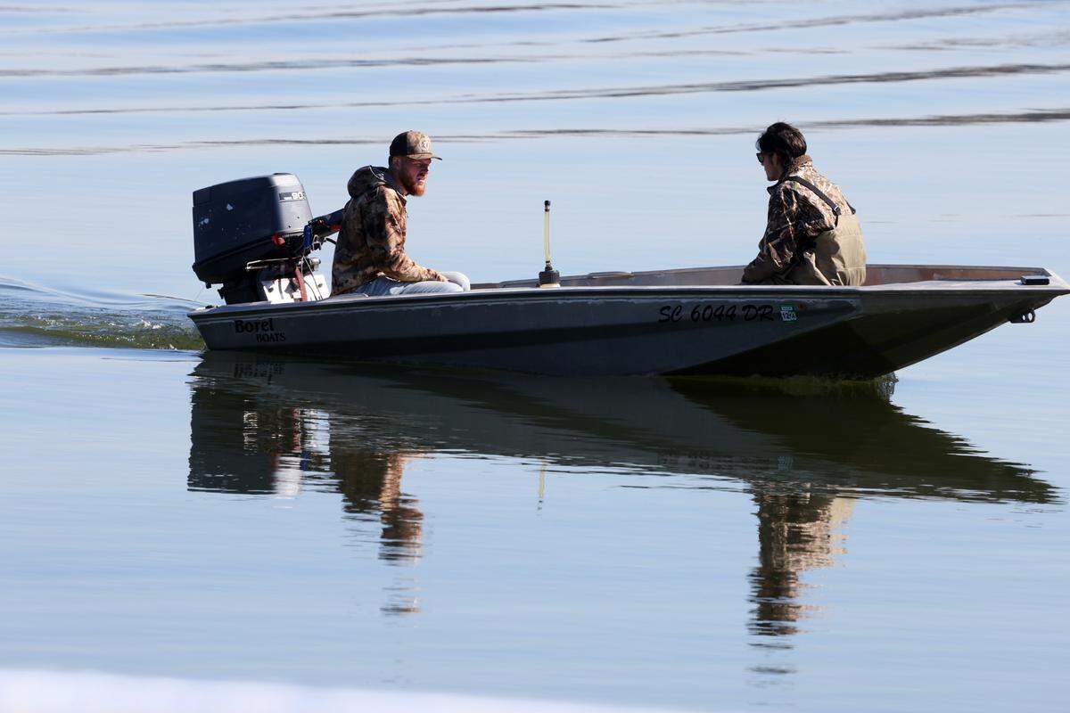 Tristan Scott, left, and Randy Williams test out a boat at the newly updated Allison Creek Park in Lake Wylie on Friday.