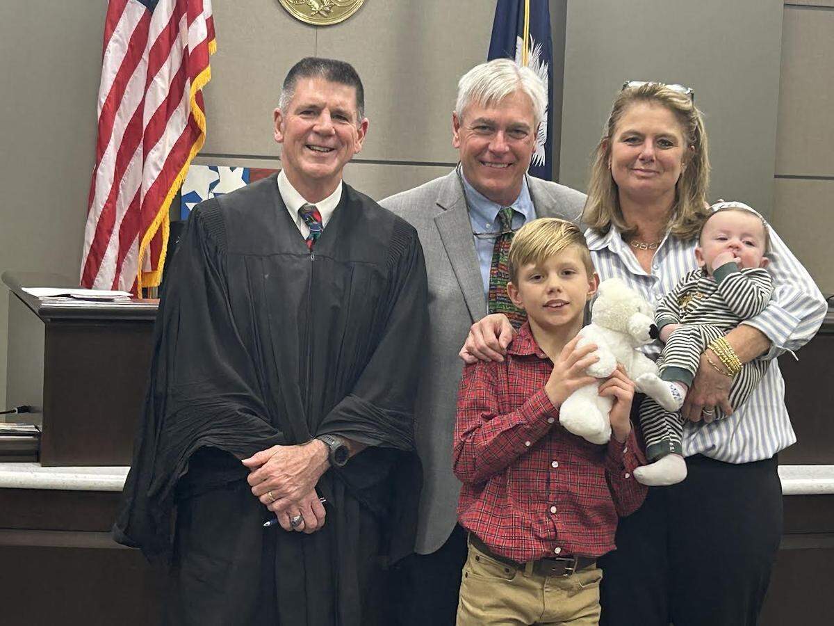 York County Family Court Judge David Guyton, left, with the Anderson family on Dec. 23, 2025, for the adoption of baby Jude.