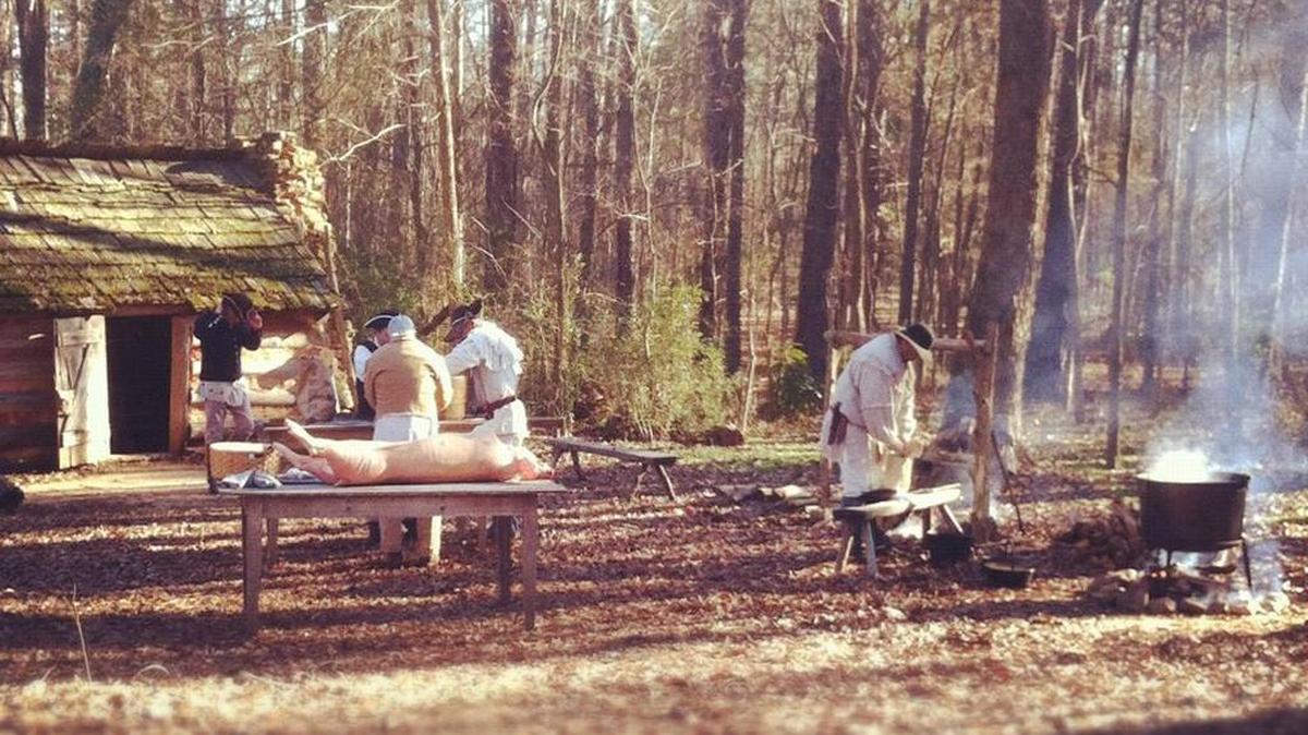Historically dressed interpreters present pork-processing activities at Hog Butchering Day at Historic Brattonsville in McConnells.