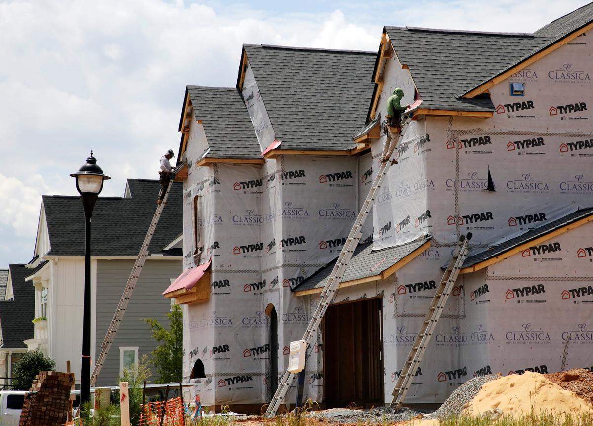 In this file photo, a construction crew work on a new home in the Arden Mill subdivision in Fort Mill.