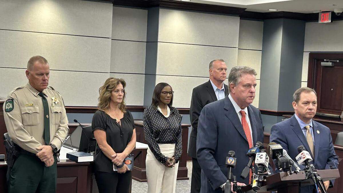 South Carolina prosecutors Kevin Brackett, center front, and David Pascoe, right front, and York County Sheriff Tony Breeden, back left, with Lori Williams, Renea Barber and Stephen Federico, who are family members of crime victims, at a news conference Oct. 9., 2025, in York, South Carolina.