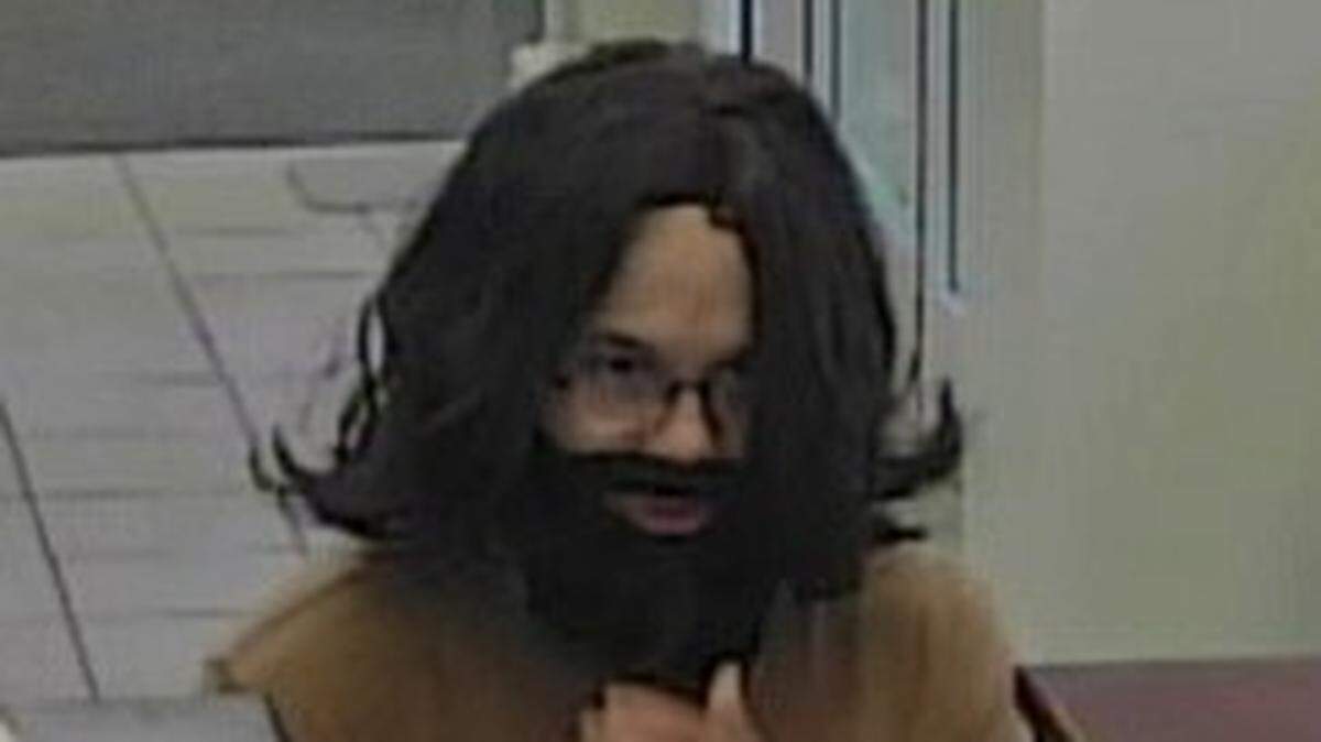 Surveillance footage of the bank robbery shows him in a wig.