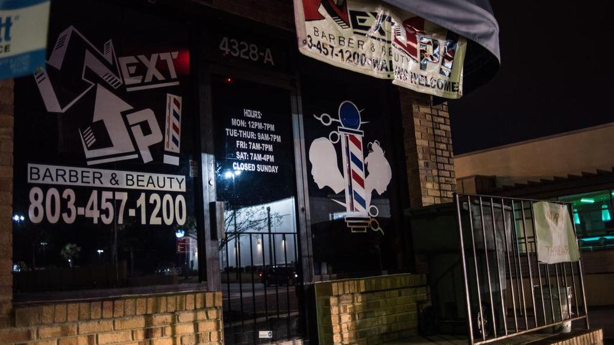 Headlights of a passing vehicle on Fort Jackson Boulevard illuminate Next Up Barber & Beauty on Saturday night in Columbia. One of two masked men who allegedly robbed patrons at the shop Friday night was shot and killed when two of the patrons pulled weapons and shot back, Columbia police said. January 23, 2016