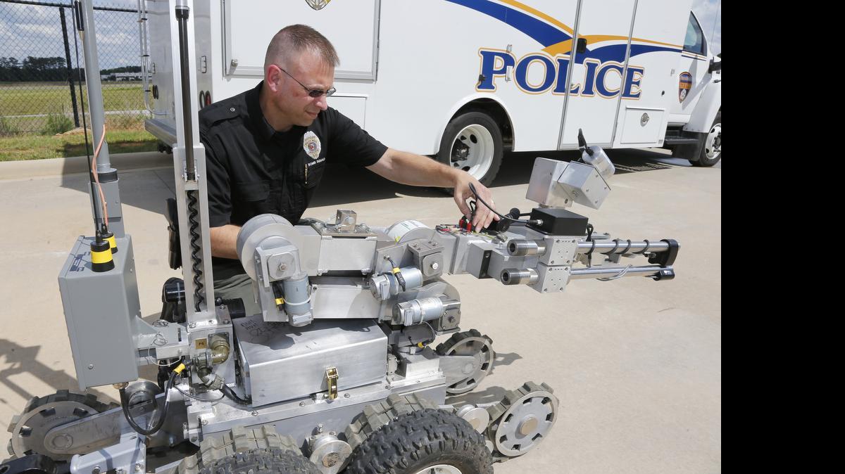 
Rock Hill Police bomb squad member Lt. Matthew Hall examines the robot. The machines, of which Rock Hill has two, can get through a door and up stairs, pick up small items and take X-ray pictures.
