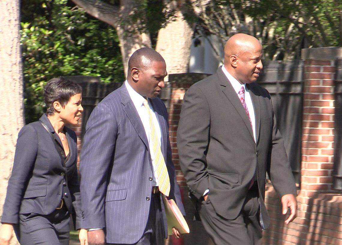 Suspended Chester County Sheriff Alex Underwood, right, walks to the federal courthouse in Columbia Tuesday with his wife Angel Underwood, left, and his attorney Stanley Myers.