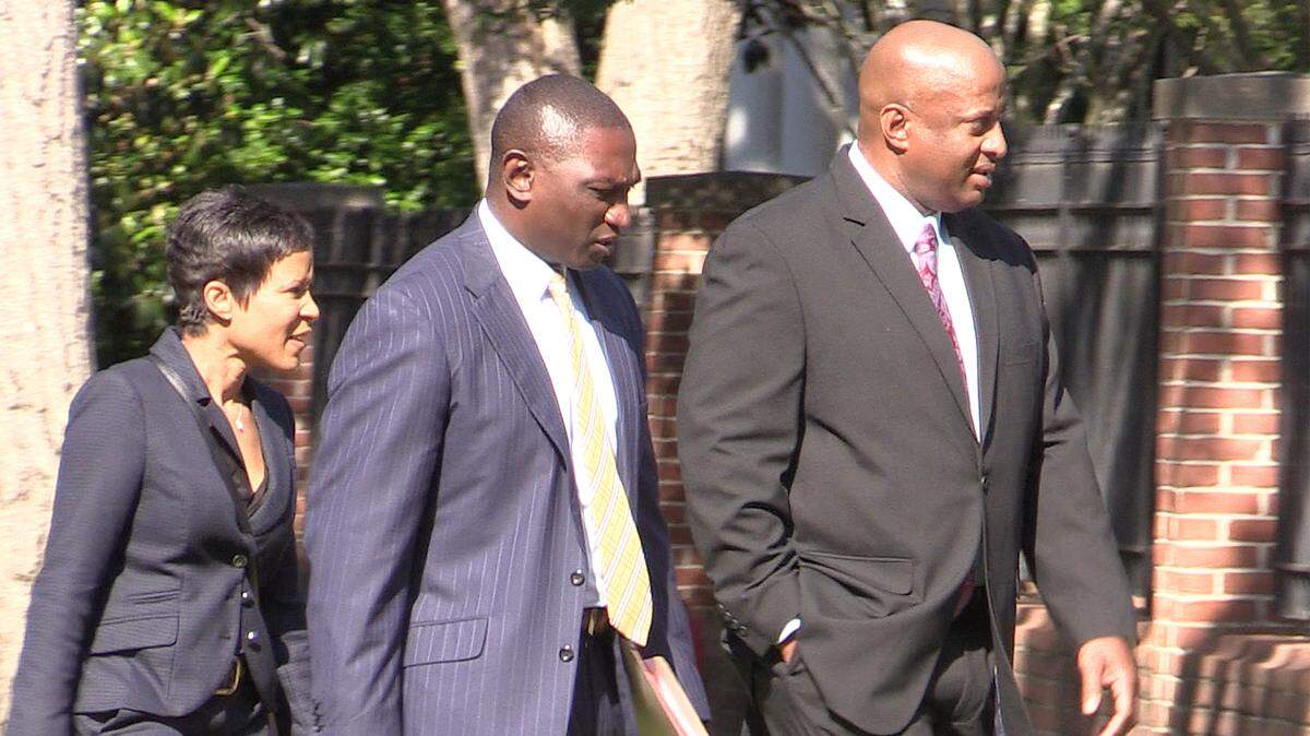 Suspended Chester County Sheriff Alex Underwood, right, walks to the federal courthouse in Columbia in 2019 with his wife Angel Underwood, left, and his attorney Stanley Myers.