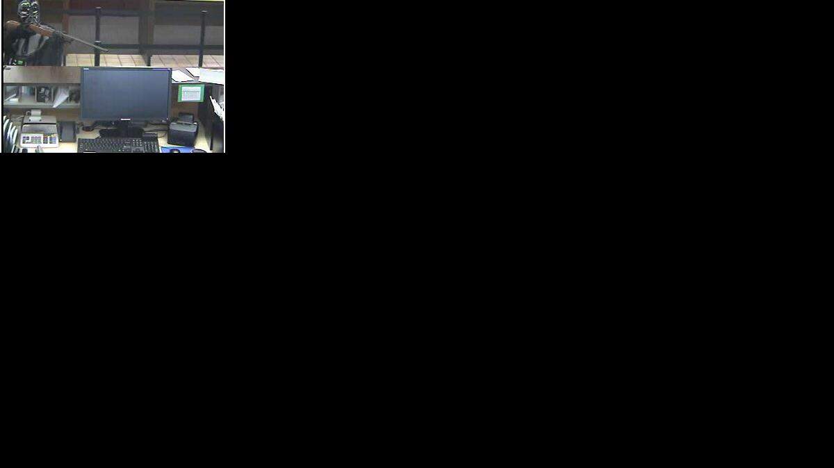 
Pineville police say the man in this surveillance photo, who is wearing a Darth Vader mask and holding a long gun, robbed the State Employees Credit Union on Pineville-Matthews Road on Monday.



