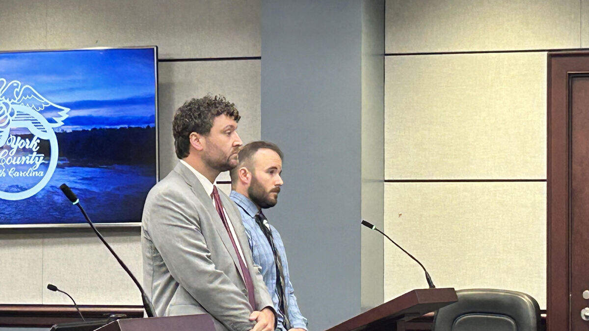 Former Charlotte-Mecklenburg police officer Dylan Lineberger, right, with his lawyer, Chris Lusk, in York County criminal court on Sept. 18, 2025. Lineberger is charged with harassment of his ex-girlfriend in Rock Hill.