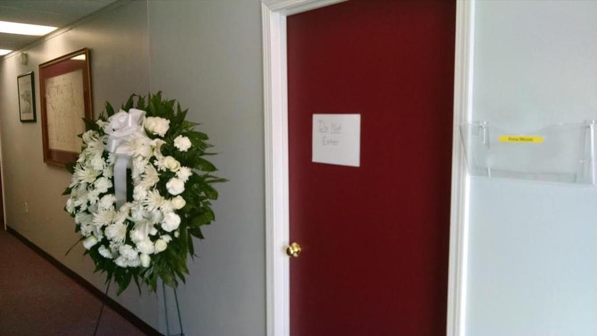 A wreath sits outside the former office of Anna Moore at the York County manager’s office. Moore’s colleagues ordered the wreath Tuesday and placed it beside the late assistant manager’s office, which was ordered sealed by investigators in her murder.