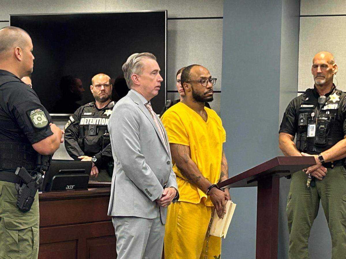 Marques Quantez Heath, in yellow, in York County, South Carolina court on Wednesday, July 10, 2024, with his lawyer, York County Public Defender B.J. Barrowclough. Heath is in a South Carolina prison on a life without parole sentence but faces another trial in August for murder and other charges from an alleged 2019 violent crime spree.
