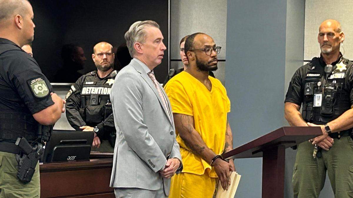 Marques Quantez Heath, in yellow, in York County, South Carolina court on Wednesday, July 10, 2024, with his lawyer, York County Public Defender B.J. Barrowclough. Heath is in a South Carolina prison on a life without parole sentence but faces another trial in August for murder and other charges from an alleged 2019 violent crime spree.