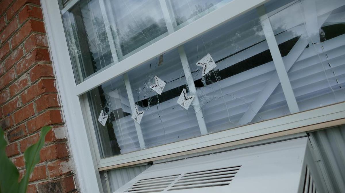 
Bullet holes in the front window of a house on Frank Street, where someone fired several rounds into the home Aug. 2. On Sunday, a man was shot outside another Frank Street home and later died at a Charlotte hospital. 
