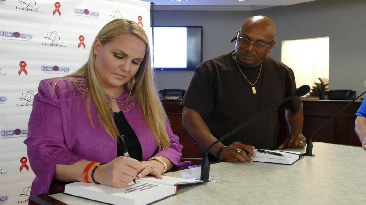 
Forensic criminologist Laura Pettler signs a copy of her book for Pageland police Sgt. James Whitaker, who was one of about 30 lawmen to attend Pettler’s workshop on cold cases in Lancaster on Tuesday.

