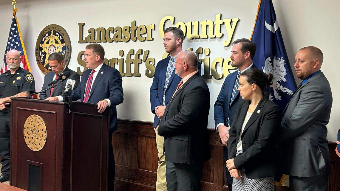 Lancaster County, S.C. Sheriff Barry Faile, center at podium, talks at a news conference Monday about the arrest of six undocumented immigrants from Honduras on murder charges in the shooting death of a woman May 2.
