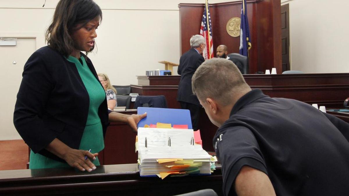 Rock Hill police Detective Phil Tripp reads records from electronic devices and social media as defense attorney Twana Burris-Alcide listens Wednesday during a probable cause hearing for Kenneth Andrew Williams, a former Northwestern High School assistant principal charged with sexual misconduct with a minor. A circuit court judge ruled Wednesday that probable cause exists to prosecute Williams.