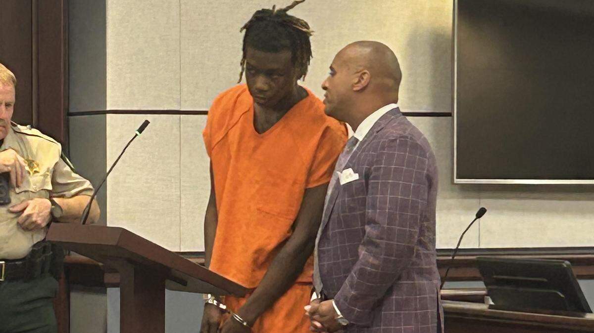 Jalen Daquavious Thames, in orange, listens to his lawyer, Todd Rutherford, in York County criminal court on Thursday, Nov. 20, 2025. 