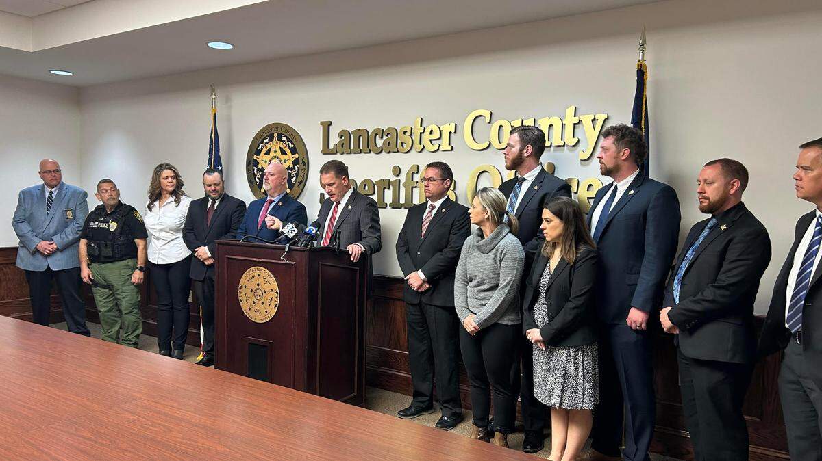 Lancaster County, South Carolina Sheriff Barry Faile, center, on March 13, 2024, announces the arrest of a man for the murder of a 65-year-old woman.