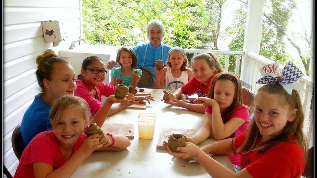 Catawba Indian Chief Bill Harris will be honored Wednesday with a state award for his artistry and advocacy in Catawba pottery. Harris, pictured here with participants in the tribe’s Summer Camp Cultural Immersion Program, began learning the craft at age 18 and teaches kids about pottery through the camp and by speaking with school and community groups.