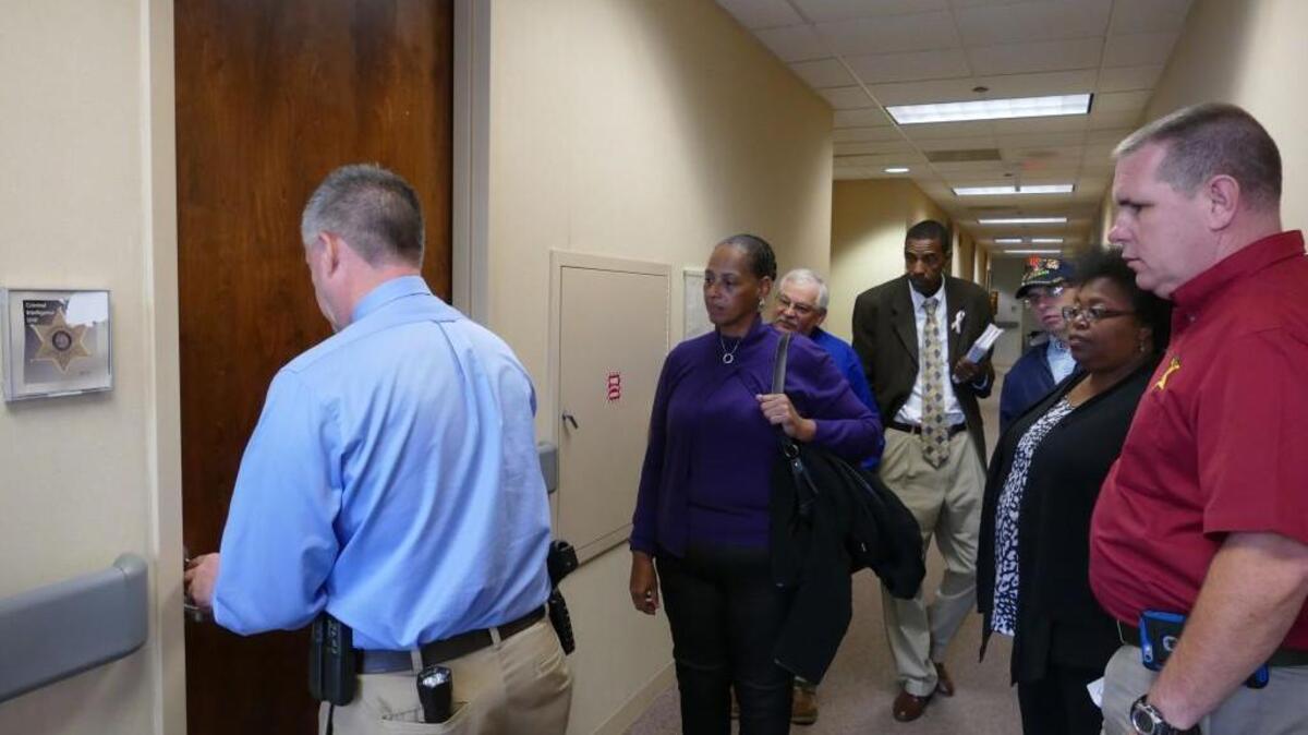 
Sheriff’s Office Capt. Jerry Hoffman unlocks a door for a tour group going through the Moss Justice Center on Sunday. The law enforcement center was opened to voters to examine the facility needs ahead of a $90 million bond vote on Nov. 3.

