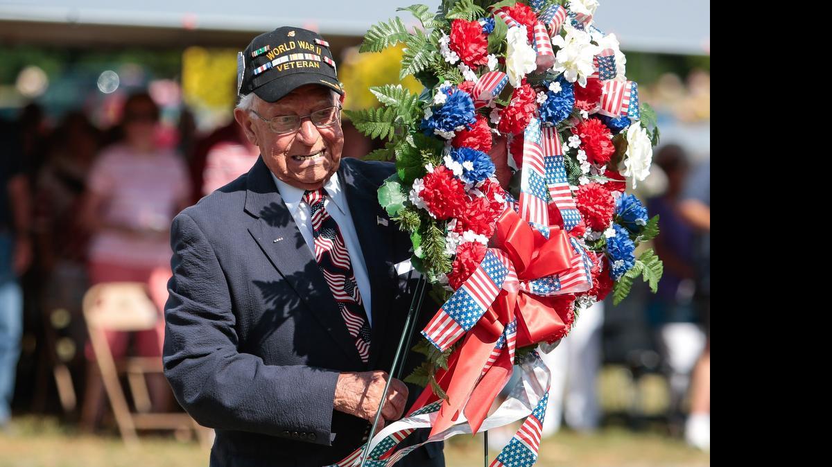 WWII veteran and Silver Star recipient James A. Ress, staff sgt. Army Air Corps, Ret., places a wreath for fallen veterans Sunday during a Memorial Day Ceremony at the York County Veterans Memorial .