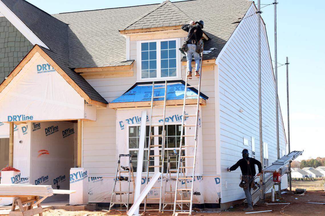 A construction crew works on a house in the Roselyn neighborhood in Lancaster. More than 1,800 homes in that neighborhood could be joined by two communities across U.S. 521, adding more than 1,500 homes.