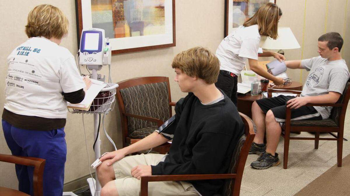 
Students at last year’s Heart of a Champion event get their blood pressure checked, just one of a number of cardio tests given to them. 
