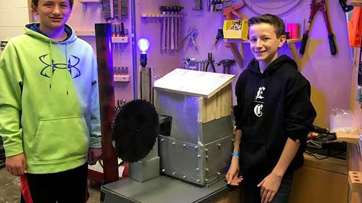 Robotics students Johnathan Smith and Will Sander stand with a STEAM-inspired prop that Fort Mill Middle School’s musical theater class and the Gateway to Technology robotics club created for the school’s upcoming production of “Beauty and the Beast, Jr.”