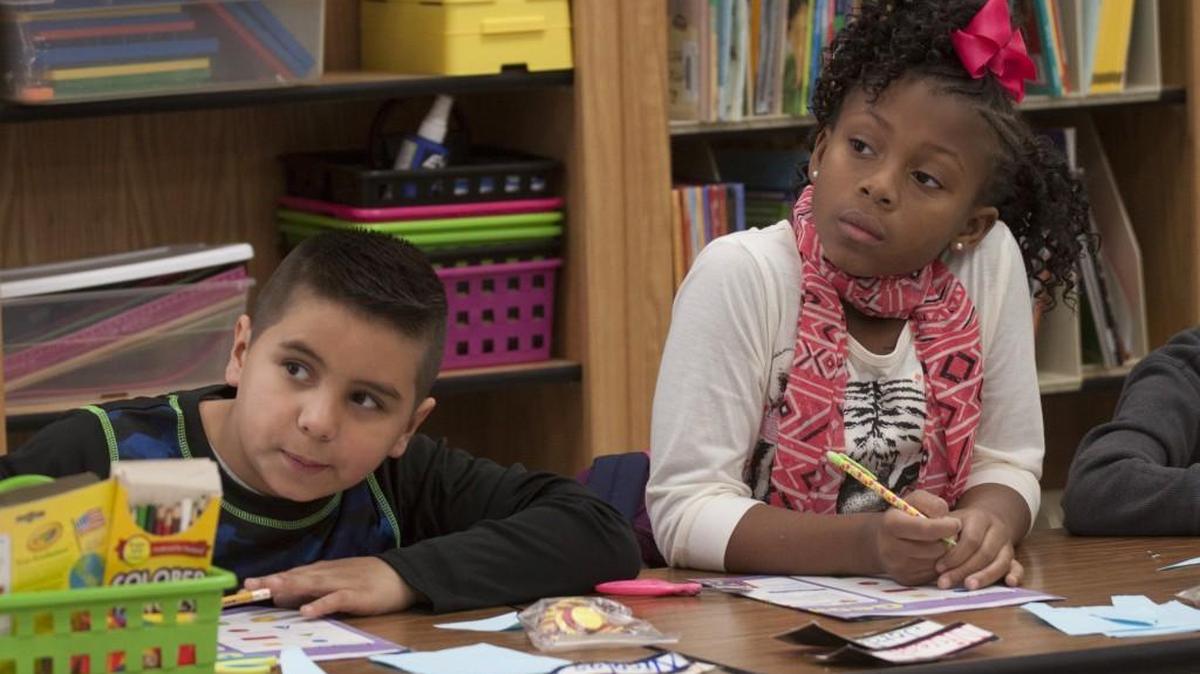 Nicolas Hernandez, 8, left, and Jordan Lightner, 7, listen to a lesson in the second-grade Spanish immersion class at Ebinport Elementary School in this file photo.