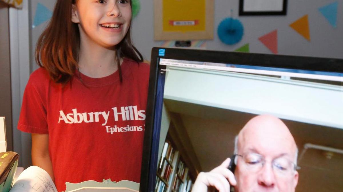 Grace Stevenson, 10, a fifth-grader at York Preparatory Academy, is a fan of children’s author Jerry Pallotta. Thursday while her class was watching on Skype Pallotta dedicated his latest book to her. Grace talks with Pallotta by Skype.