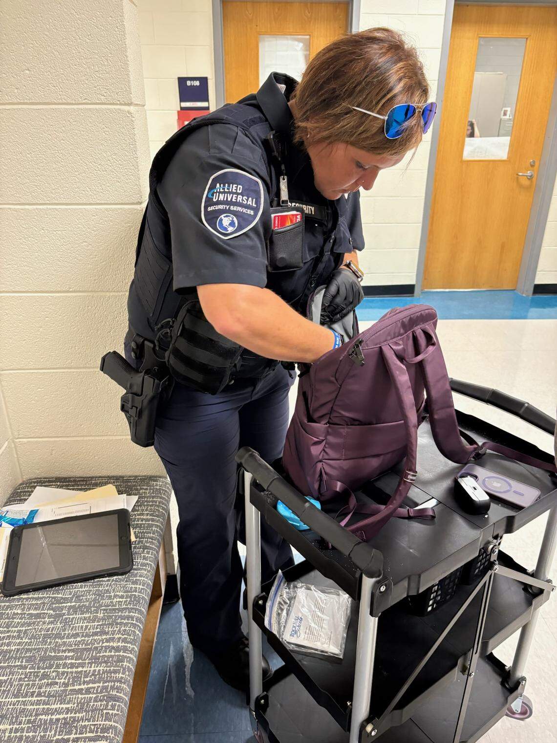 A security officer performs a routine safety screening in a Rock Hill school. Rock Hill uses daily screening to prevent weapons from entering schools.