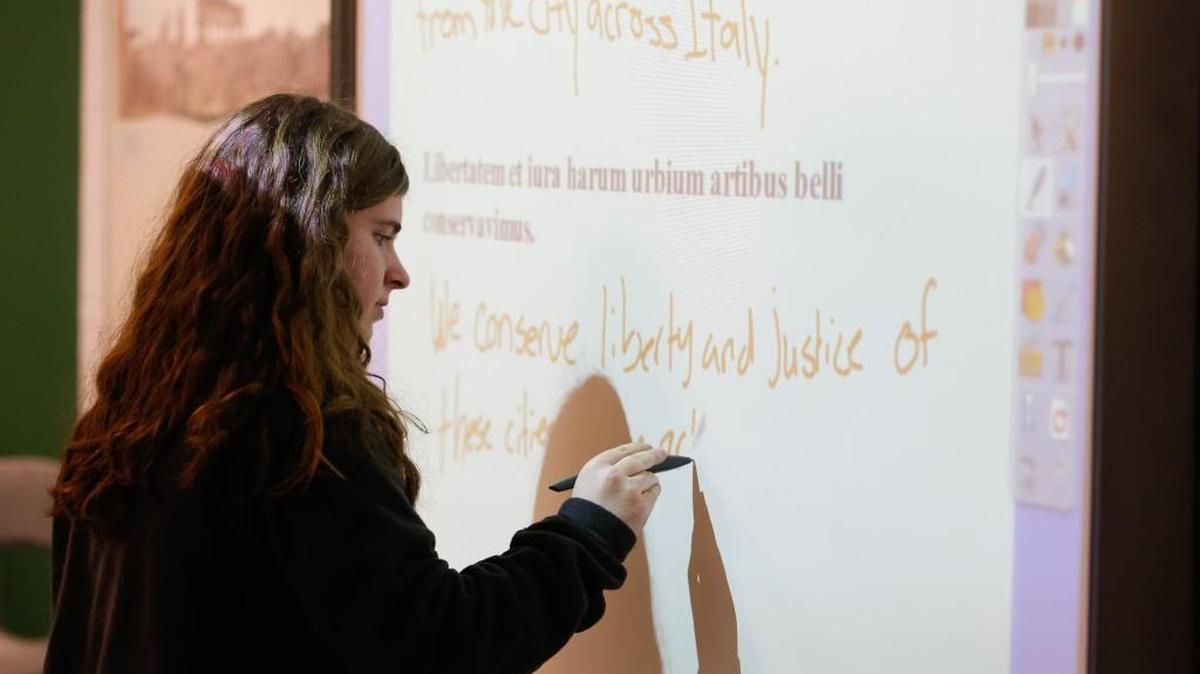 Laura Tripp works through a translation Monday in a before-school Latin class at York Comprehensive High School.