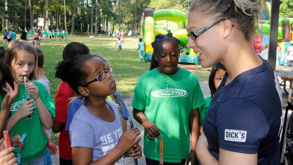 Olympic wrestling hopeful Veronica Carlson talks to students at Richmond Drive Elementary Friday during their field day.